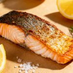 Air fryer crispy skin salmon with a flaky tender salmon fillet, extra crispy golden skin, fresh dill, lemon wedges, and flaky sea salt, served as a flavorful and healthy seafood dinner.