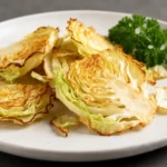 Air fryer cabbage chips with crispy golden edges and tender centers, roasted until lightly browned and served as a healthy low calorie snack.