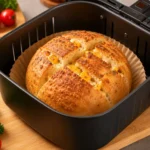 High protein cottage cheese bread in the air fryer with a golden crust, fluffy interior, melted cheese pockets, and a protein packed texture, baked inside an air fryer basket.