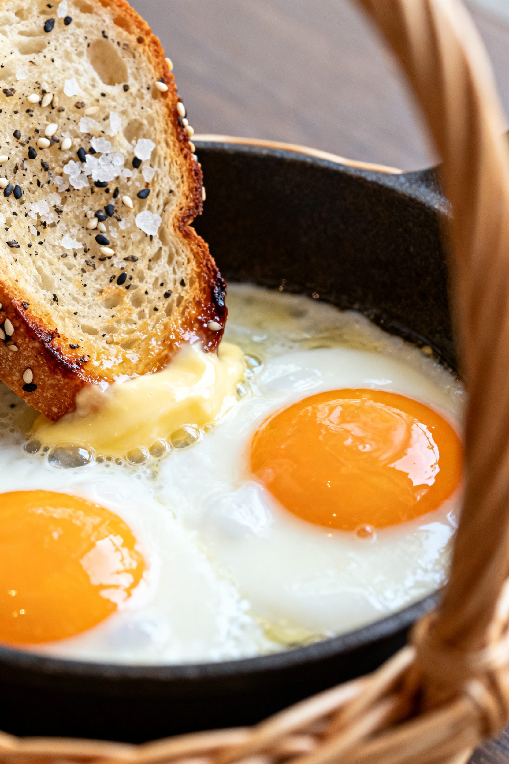 5-inch cutout, whites just turning opaque at the edges and the yolk glossy and jammy; edges of bread
