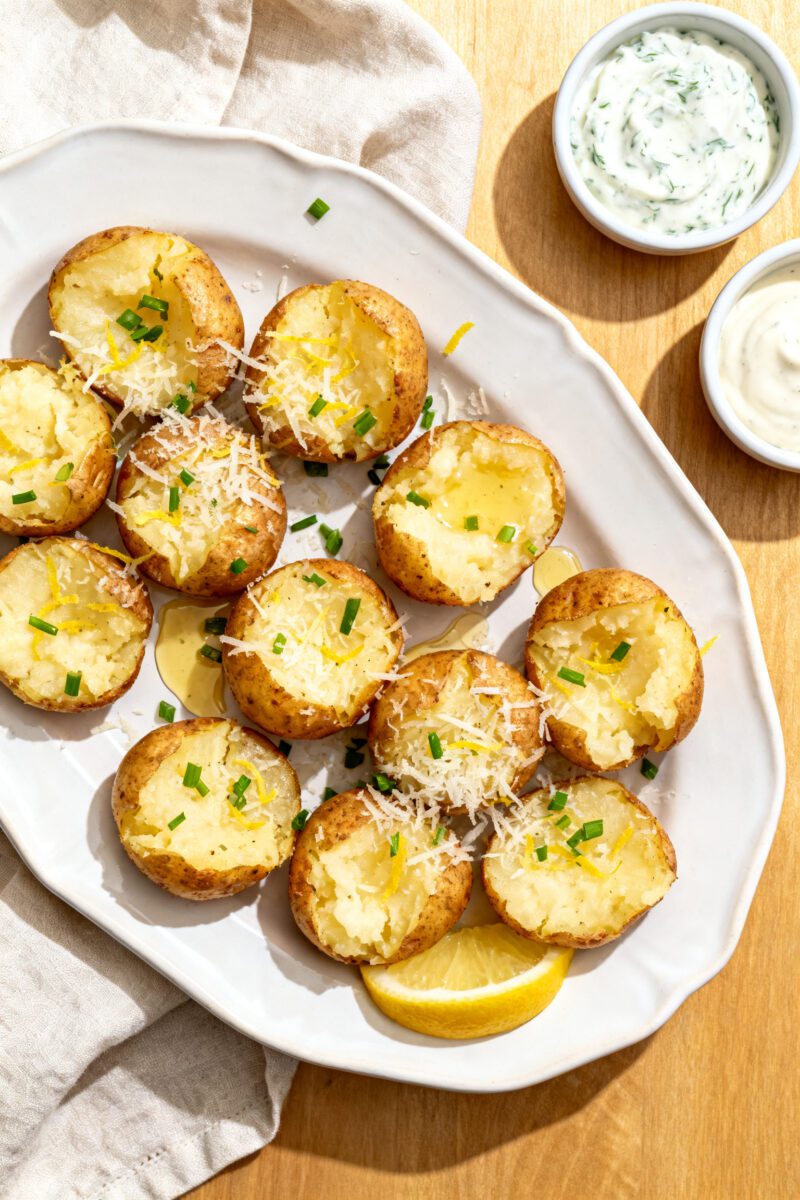 Final plated dish: Restaurant-quality presentation of air fryer smashed mini potatoes on a white cer