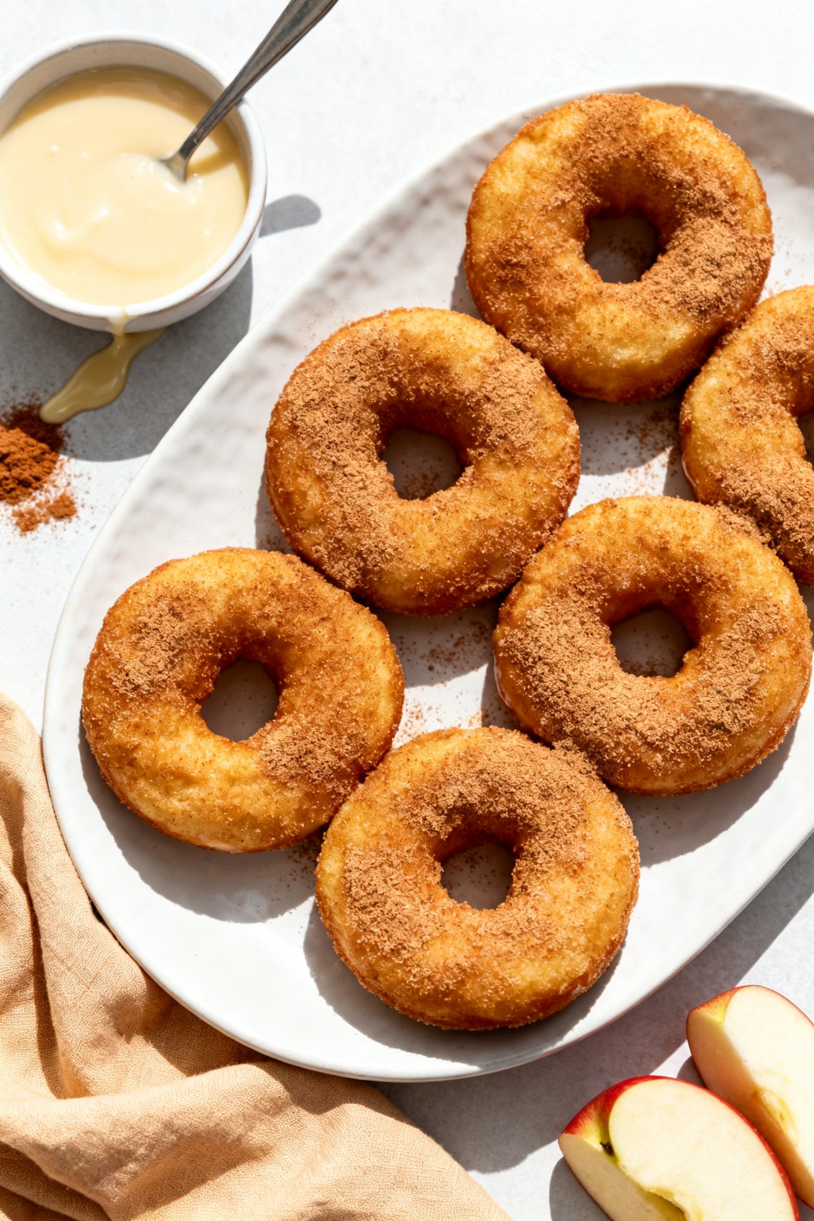 Overhead final presentation: A brunch-ready platter of Air Fryer Apple Ring Donuts on a matte white 