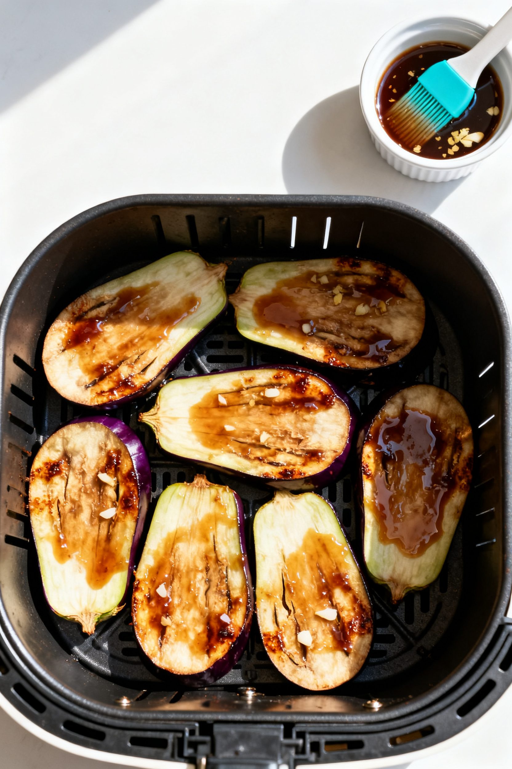 Tasty top view (cooking process): Overhead shot of halved Japanese eggplant in the air fryer during 