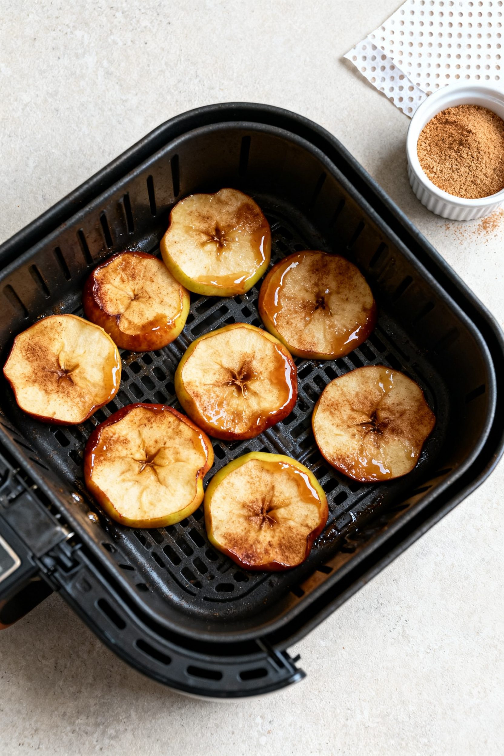 Tasty top view (overhead): Single-layer arrangement of cooked cinnamon apple rounds in the open air 