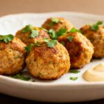 Air fryer healthy meatballs with juicy browned meatballs, fresh parsley garnish, and a creamy dipping sauce, served as a lighter high protein appetizer or weeknight dinner.
