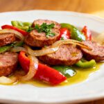 Air fryer sausage, peppers, and onions with juicy sliced sausage, roasted red and green bell peppers, sweet caramelized onions, and fresh parsley, served as a quick and flavorful weeknight meal.