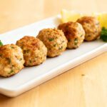 Air fryer healthy turkey meatballs with juicy lean turkey meatballs, fresh parsley, and lemon wedges, served as a high protein meal prep friendly lunch or dinner.