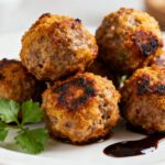 Air fryer beef meatballs with juicy browned beef meatballs, caramelized crispy edges, fresh parsley garnish, and rich pan juices, served as an easy weeknight dinner or appetizer.