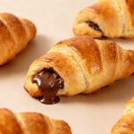 Air fryer Nutella crescent rolls with flaky golden pastry, warm gooey chocolate hazelnut filling, and buttery crisp layers, served as an easy dessert or sweet breakfast treat.