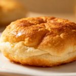 Air fryer fried bread with a crispy golden crust, soft fluffy center, and a light drizzle of honey, served as a quick breakfast, snack, or comforting side.