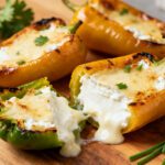 Air fryer cream cheese peppers with roasted sweet mini peppers stuffed with creamy melted cream cheese, lightly browned tops, and fresh parsley, served as an easy appetizer or snack.