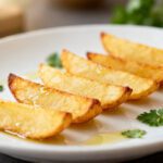 Air fryer hot dog chips with crispy thin hot dog slices, golden browned edges, and a crunchy texture, served as a fun high protein snack with dipping sauce.
