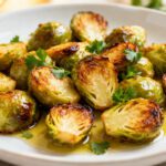 Best air fryer Brussels sprouts with crispy caramelized Brussels sprouts, golden browned edges, fresh parsley, and olive oil, served as a flavorful healthy vegetable side dish.