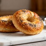 Air fryer gluten free bagels with a golden chewy crust, everything bagel seasoning, soft fluffy interior, and cream cheese, served as an easy homemade gluten free breakfast.