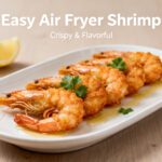 Easy air fryer shrimp with juicy tender shrimp, lightly seasoned crispy edges, fresh parsley, lemon wedges, and buttery pan juices, served as an easy high protein seafood meal.