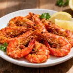 Air fryer Cajun shrimp with juicy shrimp coated in bold Cajun seasoning, fresh parsley, and lemon wedges, served as an easy spicy high protein seafood dinner.