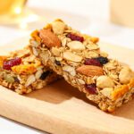 Air fryer granola bars with chewy rolled oats, almonds, mixed seeds, dried cranberries, and crunchy granola clusters, served as an easy homemade snack.