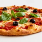 Air fryer low carb pizza with a crispy golden keto friendly crust, melted mozzarella cheese, pepperoni, black olives, fresh basil, and rich tomato sauce, served as a satisfying low carb dinner.
