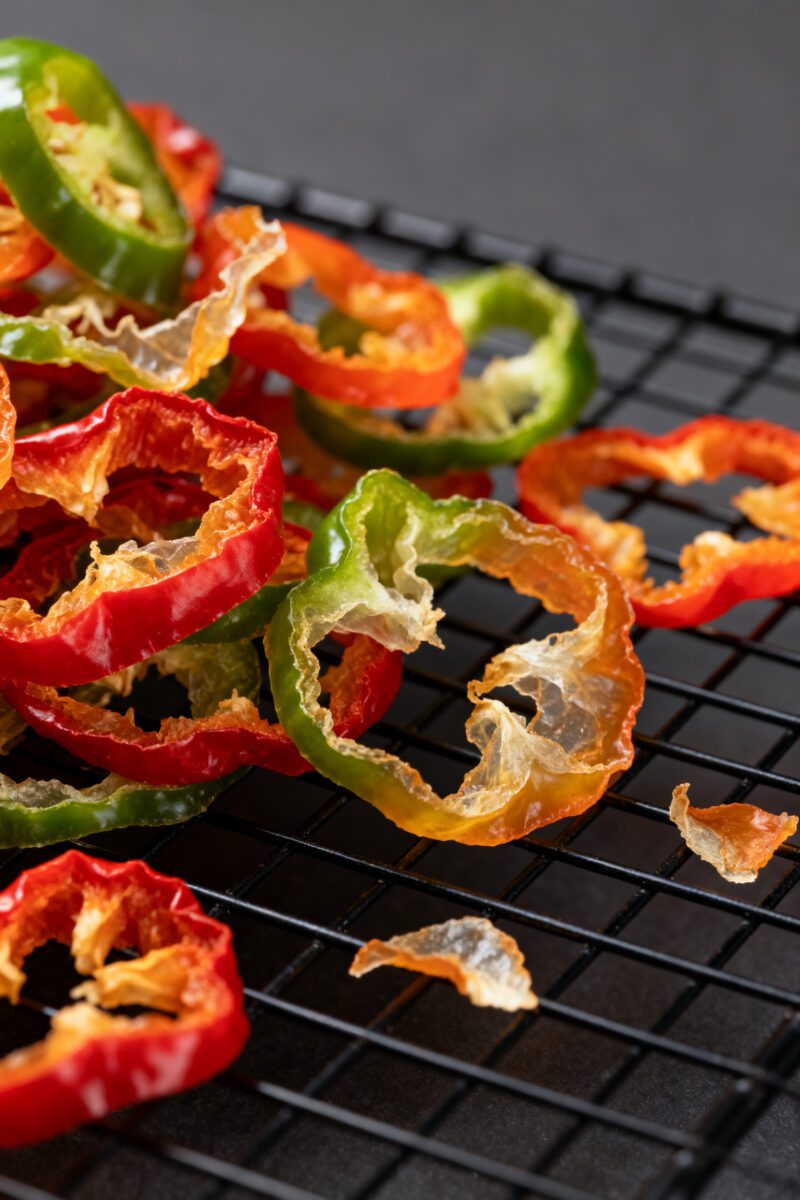 Close-up detail: Ultra-close macro of dehydrated mixed pepper rings (jalapeño, Fresno, and sweet mi