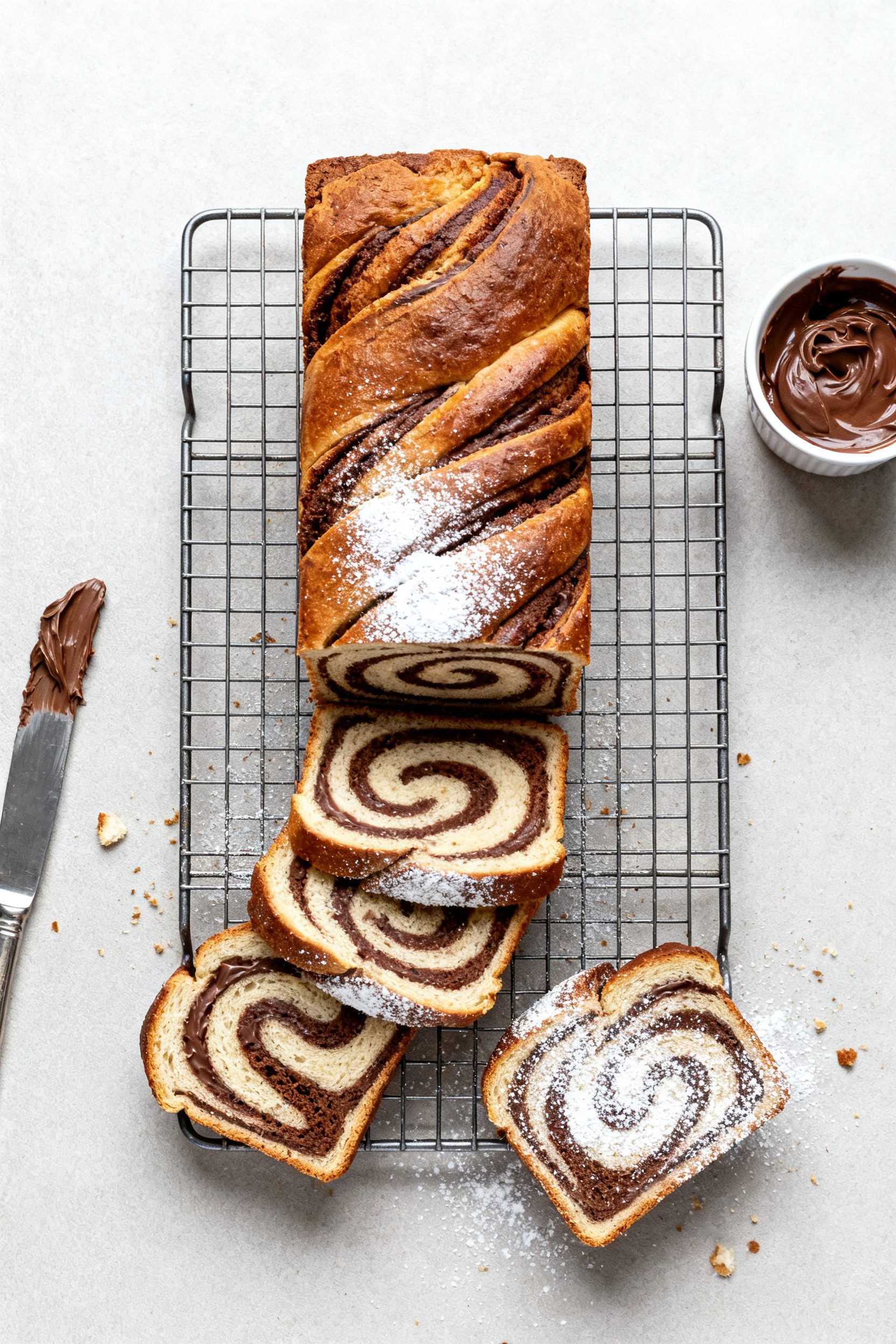Overhead “tasty top view” of the cooled loaf sliced on a wire rack, revealing dramatic figure-ei