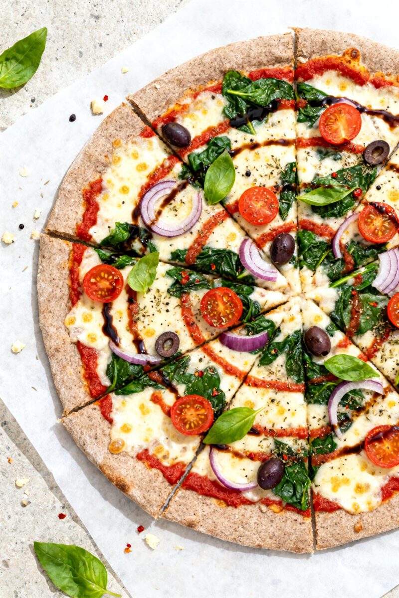 Tasty top view: Overhead shot of a just-finished whole-wheat thin-crust Veggie Supreme pizza on parc